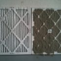 Two dirty air filters, one with vertical stripes and one with a diamond pattern, needing HVAC maintenance.