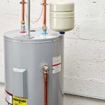 Water heater with copper pipes and expansion tank for plumbing system in Staten Island residential home.
