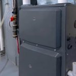 Gray industrial heating unit with control knobs and vents by PAC Plumbing, Heating, and Air Conditioning.