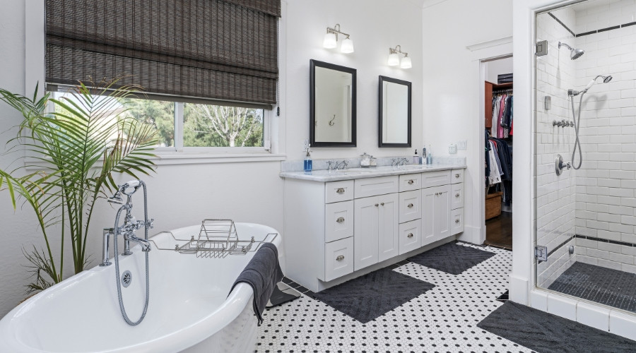 Modern bathroom featuring a freestanding tub, dual sinks with mirrors, stylish fixtures, and a walk-in shower, emphasizing comfort and functionality for renovations.